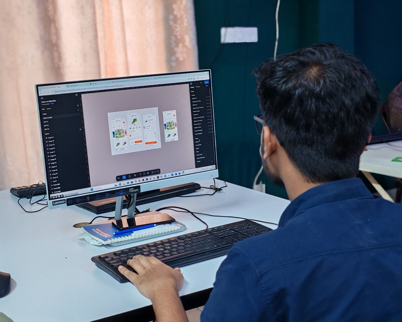 A designer working on mobile interface layouts on screen